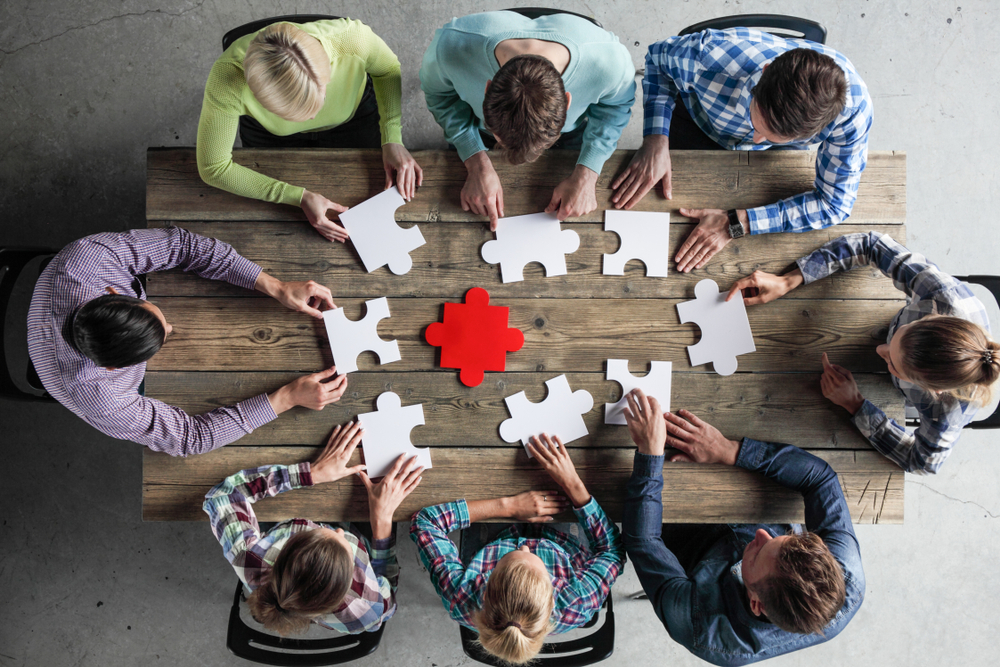 Business,People,And,Puzzle,On,Wooden,Table,,Teamwork,Concept